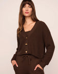 Model is wearing Recycled Sweater Cardigan in Chocolate