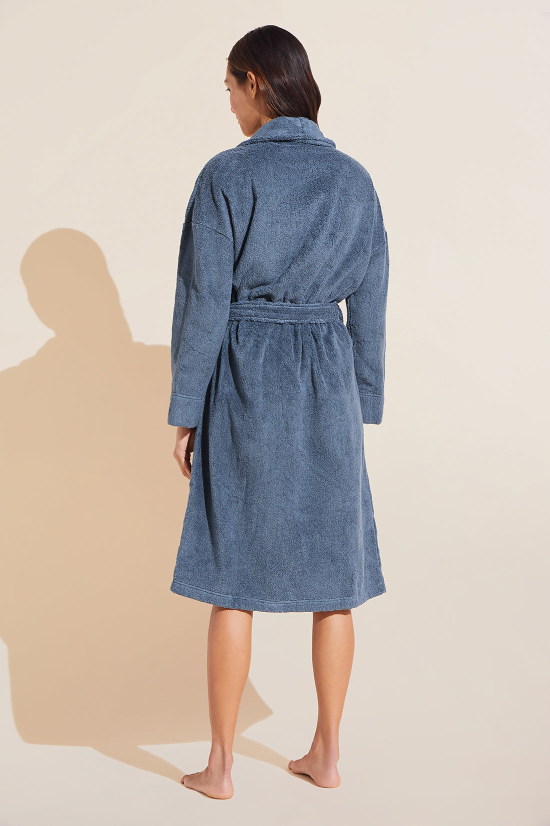 Model wears Terry Gender Neutral Robe in Coastal Blue.