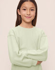 Model is wearing Kid's French Terry Sweatshirt and Jogger Set in Matcha