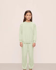 Model is wearing Kid's French Terry Sweatshirt and Jogger Set in Matcha