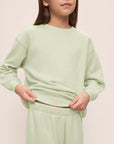 Model is wearing Kid's French Terry Sweatshirt and Jogger Set in Matcha