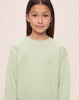 Model is wearing Kid's French Terry Sweatshirt and Jogger Set in Matcha