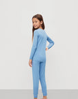 Model is wearing Kids TENCEL™ Modal Unisex Long PJ Set in Summer Blue/White