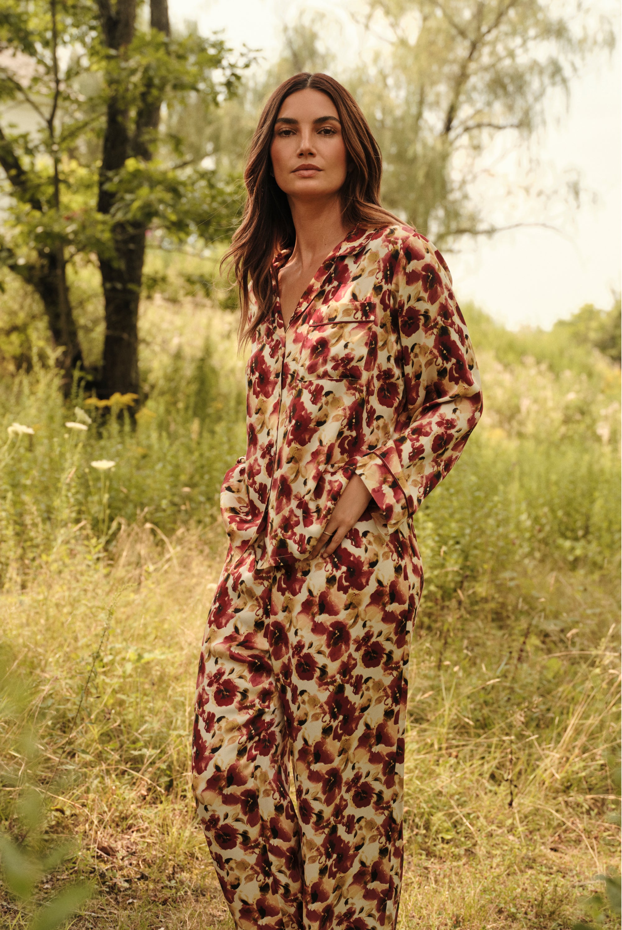 Model is wearing Inez Washable Silk Long PJ Set in Botanical Flower Merlot