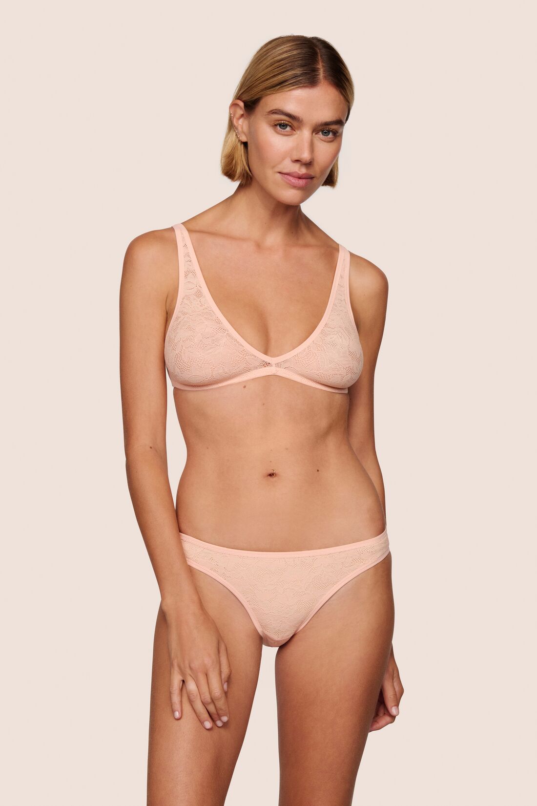 Model is wearing Soft Stretch Lace Plunge Bralette in Buff