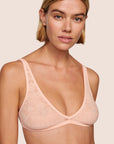 Model is wearing Soft Stretch Lace Plunge Bralette in Buff