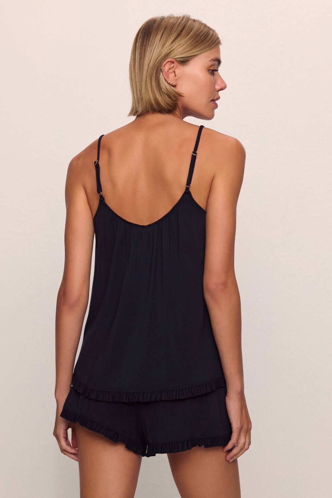 Model is wearing Gisele TENCEL™ Modal Ruffle Cami & Shortie Short Set in Black