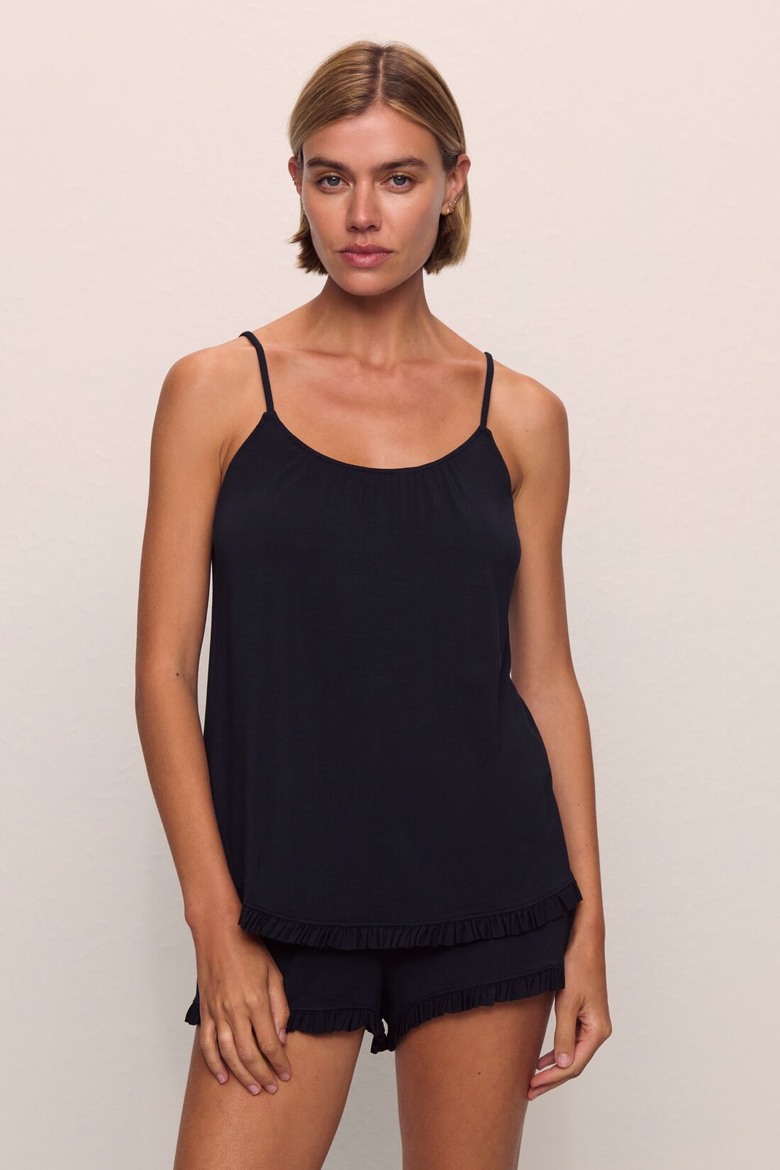 Model is wearing Gisele TENCEL™ Modal Ruffle Cami & Shortie Short Set in Black
