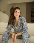 Model is wearing Eberjey x Casa Del Sol Inez Washable Silk Long PJ Set in Azulejos Navy/Navy