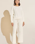 Model wears Cable Knit Recycled Sweater Straight Leg Pant in Ivory.