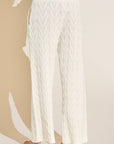 Model wears Cable Knit Recycled Sweater Straight Leg Pant in Ivory.