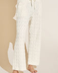 Model wears Cable Knit Recycled Sweater Straight Leg Pant in Ivory.