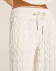 Model wears Cable Knit Recycled Sweater Straight Leg Pant in Ivory.