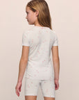 Model is wearing the Kids Printed TENCEL™ Modal Unisex Short PJ Set in Summer Daisy/Pale Mauve