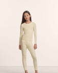 Model is wearing Kids TENCEL™ Modal Unisex Long PJ Set in Buttercream/Ivory