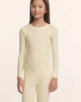 Model is wearing Kids TENCEL™ Modal Unisex Long PJ Set in Buttercream/Ivory