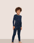 Model is wearing Kids Printed TENCEL™ Modal Unisex Long PJ Set in Forest Pine Navy/Ivory