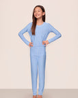 Model is wearing Kids Printed TENCEL™ Modal Unisex Long PJ Set in Nordic Stripe Vista Blue/White