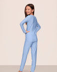 Model is wearing Kids Printed TENCEL™ Modal Unisex Long PJ Set in Nordic Stripe Vista Blue/White