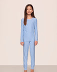 Model is wearing Kids Printed TENCEL™ Modal Unisex Long PJ Set in Nordic Stripe Vista Blue/White