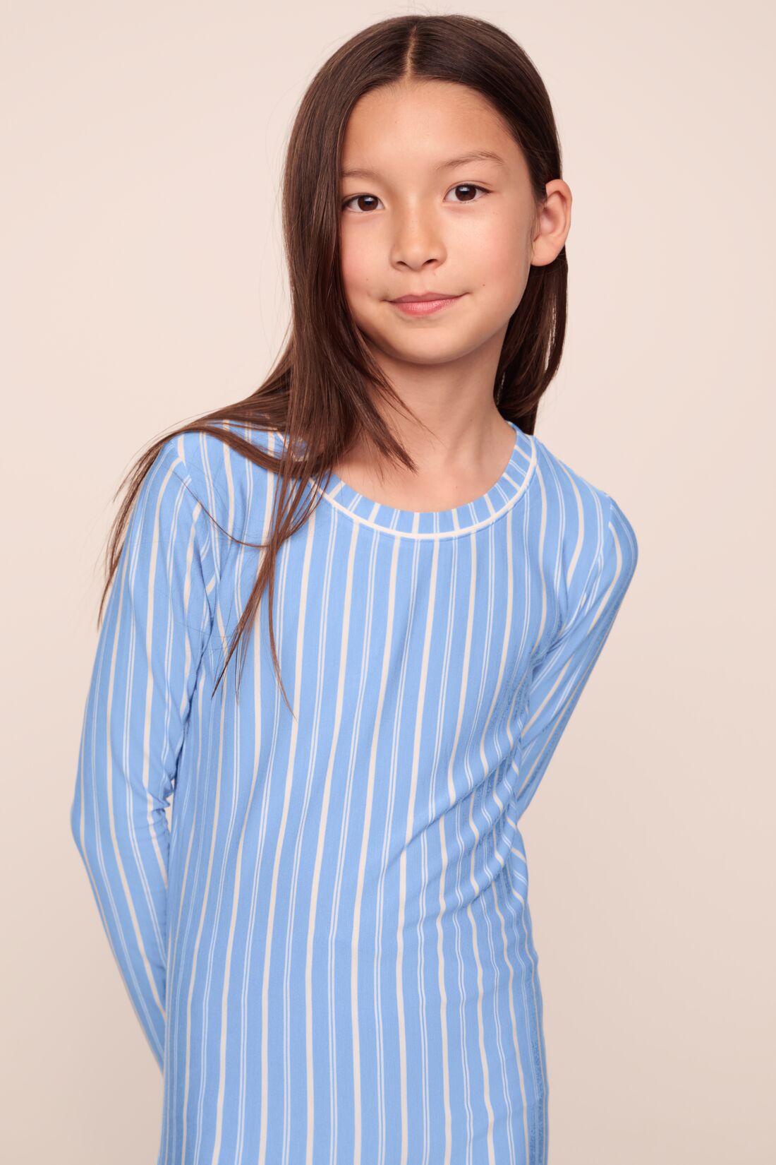Model is wearing Kids Printed TENCEL™ Modal Unisex Long PJ Set in Nordic Stripe Vista Blue/White