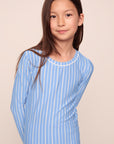 Model is wearing Kids Printed TENCEL™ Modal Unisex Long PJ Set in Nordic Stripe Vista Blue/White