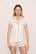 Model is wearing Gisele TENCEL™ Modal Shortie Short PJ Set in Pure Ivory/Navy