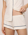 Model is wearing Gisele TENCEL™ Modal Shortie Short PJ Set in Pure Ivory/Navy