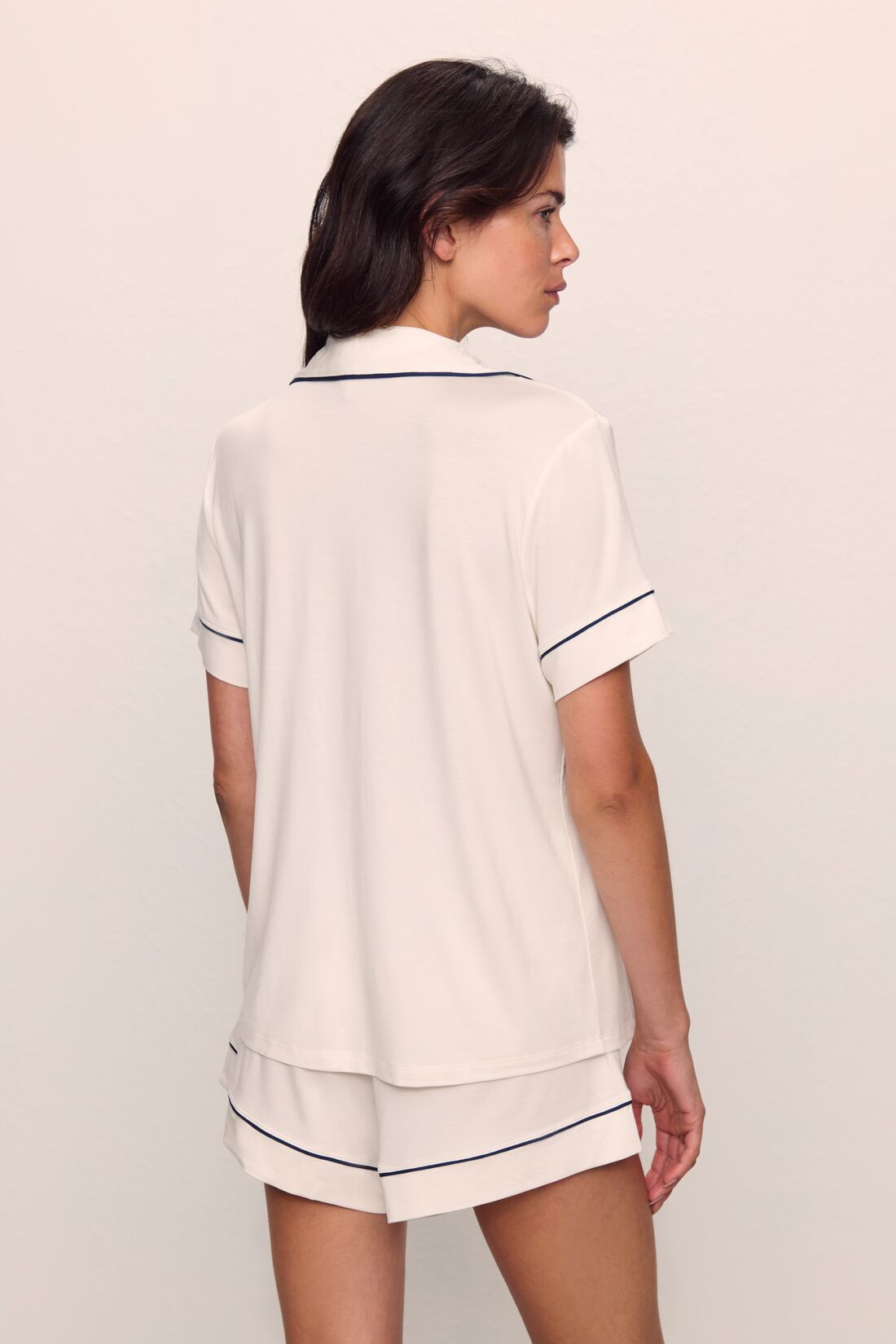 Model is wearing Gisele TENCEL™ Modal Relaxed Short PJ Set in Pure Ivory/Navy