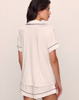 Model is wearing Gisele TENCEL™ Modal Relaxed Short PJ Set in Pure Ivory/Navy