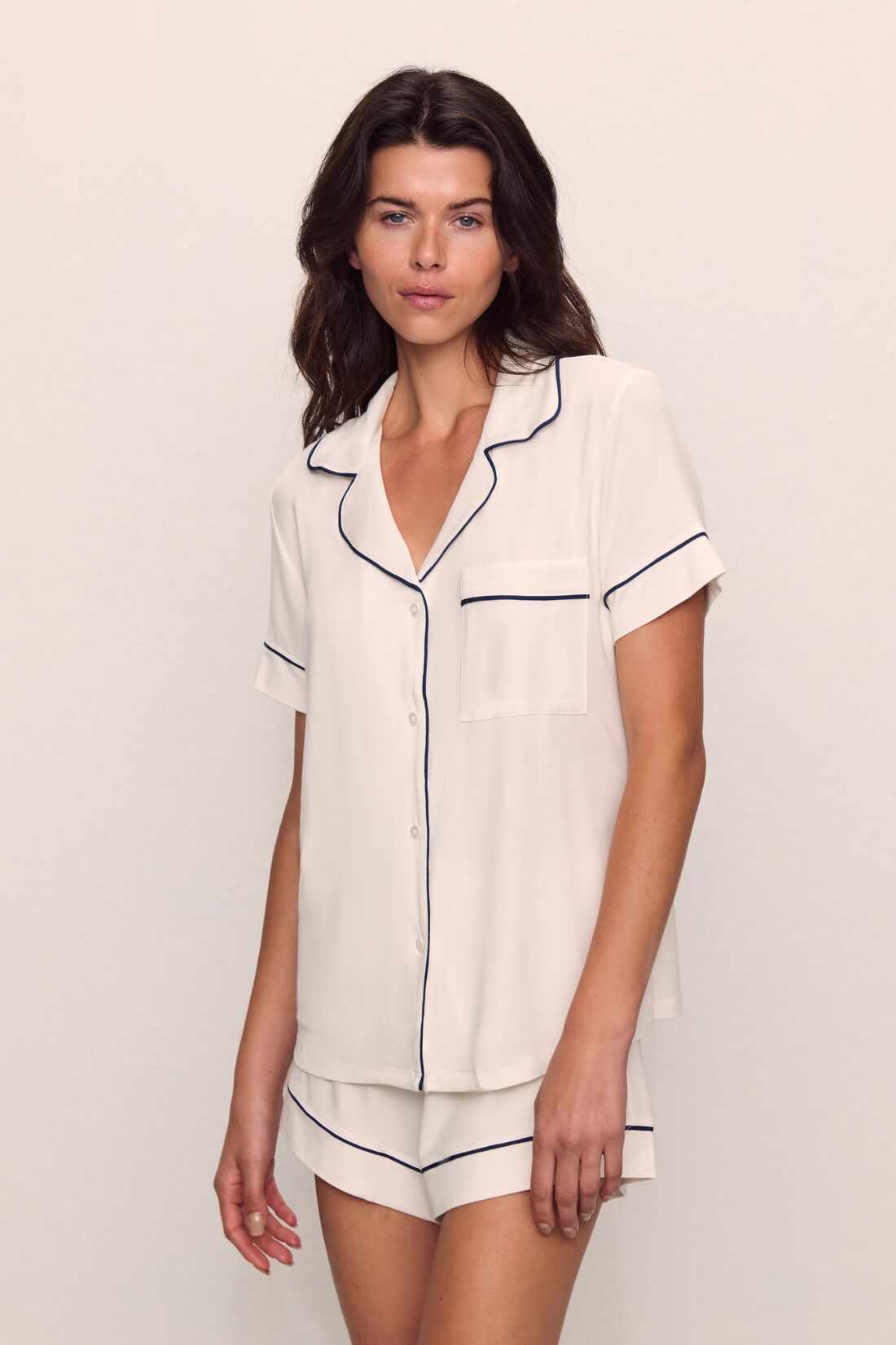Model is wearing Gisele TENCEL™ Modal Relaxed Short PJ Set in Pure Ivory/Navy
