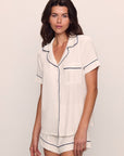 Model is wearing Gisele TENCEL™ Modal Relaxed Short PJ Set in Pure Ivory/Navy
