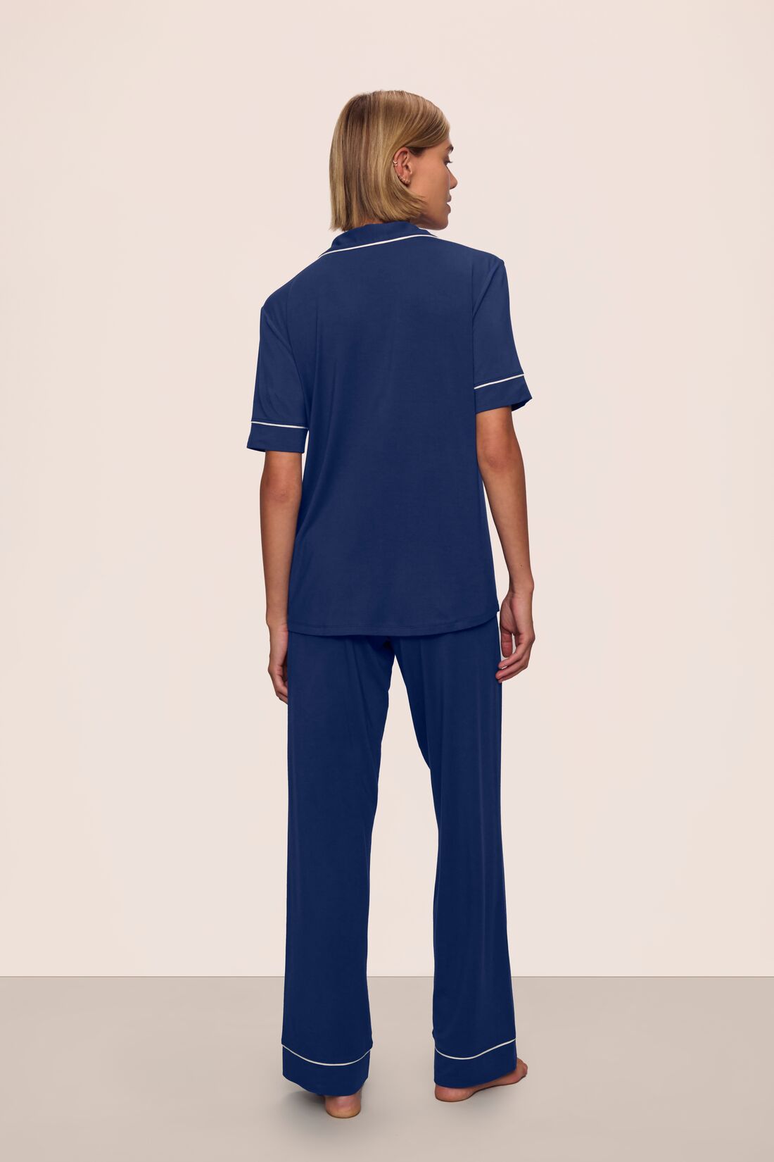 Model is wearing Gisele TENCEL™ Modal Short Sleeve & Pant PJ Set in Navy/Ivory