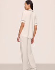 Model is wearing Gisele TENCEL™ Modal Short Sleeve & Pant PJ Set in Pure Ivory/Navy