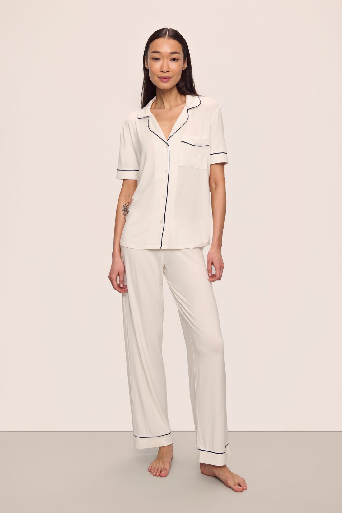 Model is wearing Gisele TENCEL™ Modal Short Sleeve & Pant PJ Set in Pure Ivory/Navy