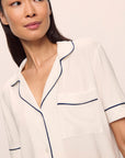 Model is wearing Gisele TENCEL™ Modal Short Sleeve & Pant PJ Set in Pure Ivory/Navy