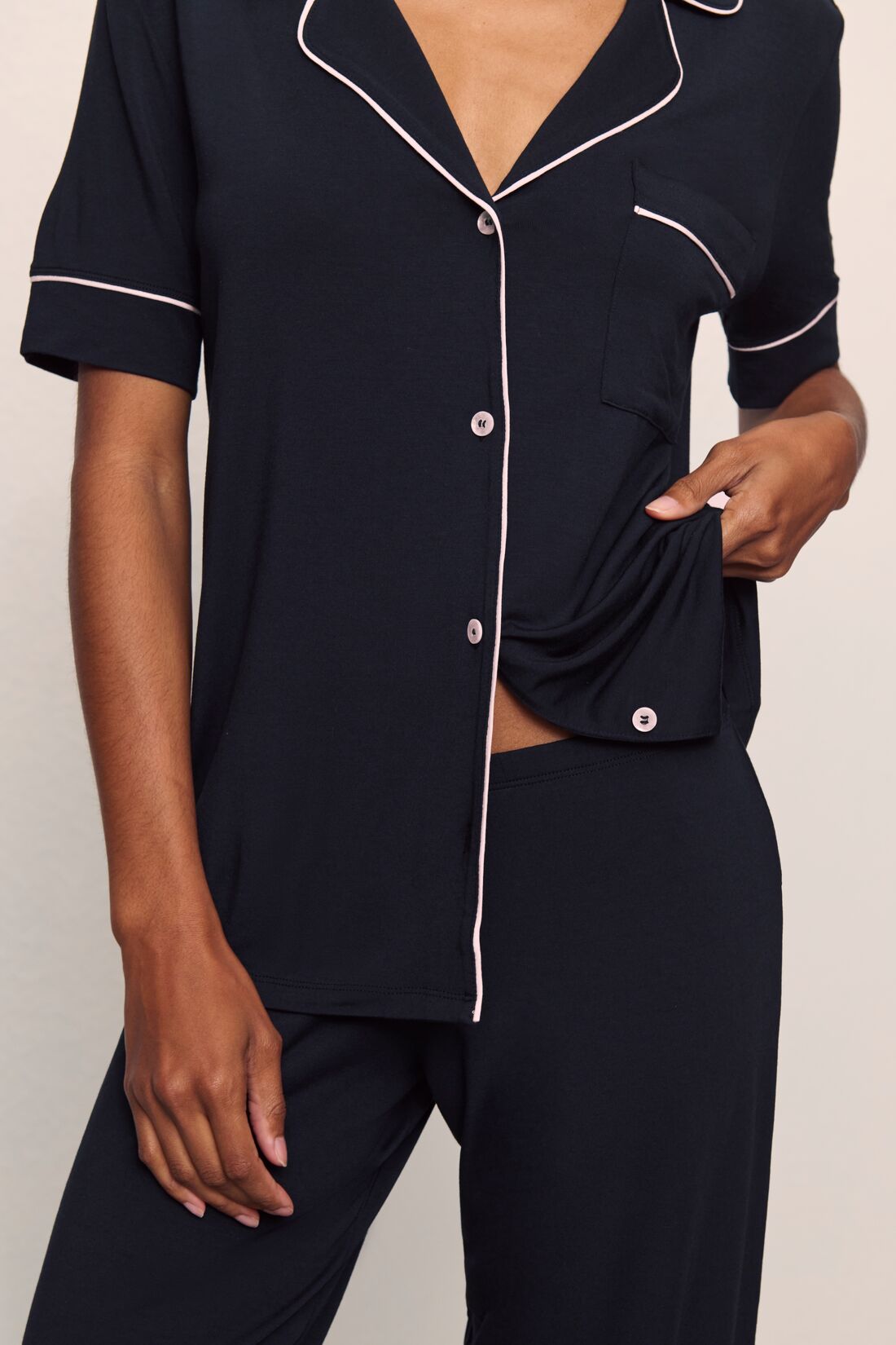 Model is wearing Gisele TENCEL™ Modal Short Sleeve & Pant PJ Set in Black/Sorbet Pink