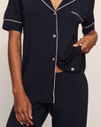 Model is wearing Gisele TENCEL™ Modal Short Sleeve & Pant PJ Set in Black/Sorbet Pink