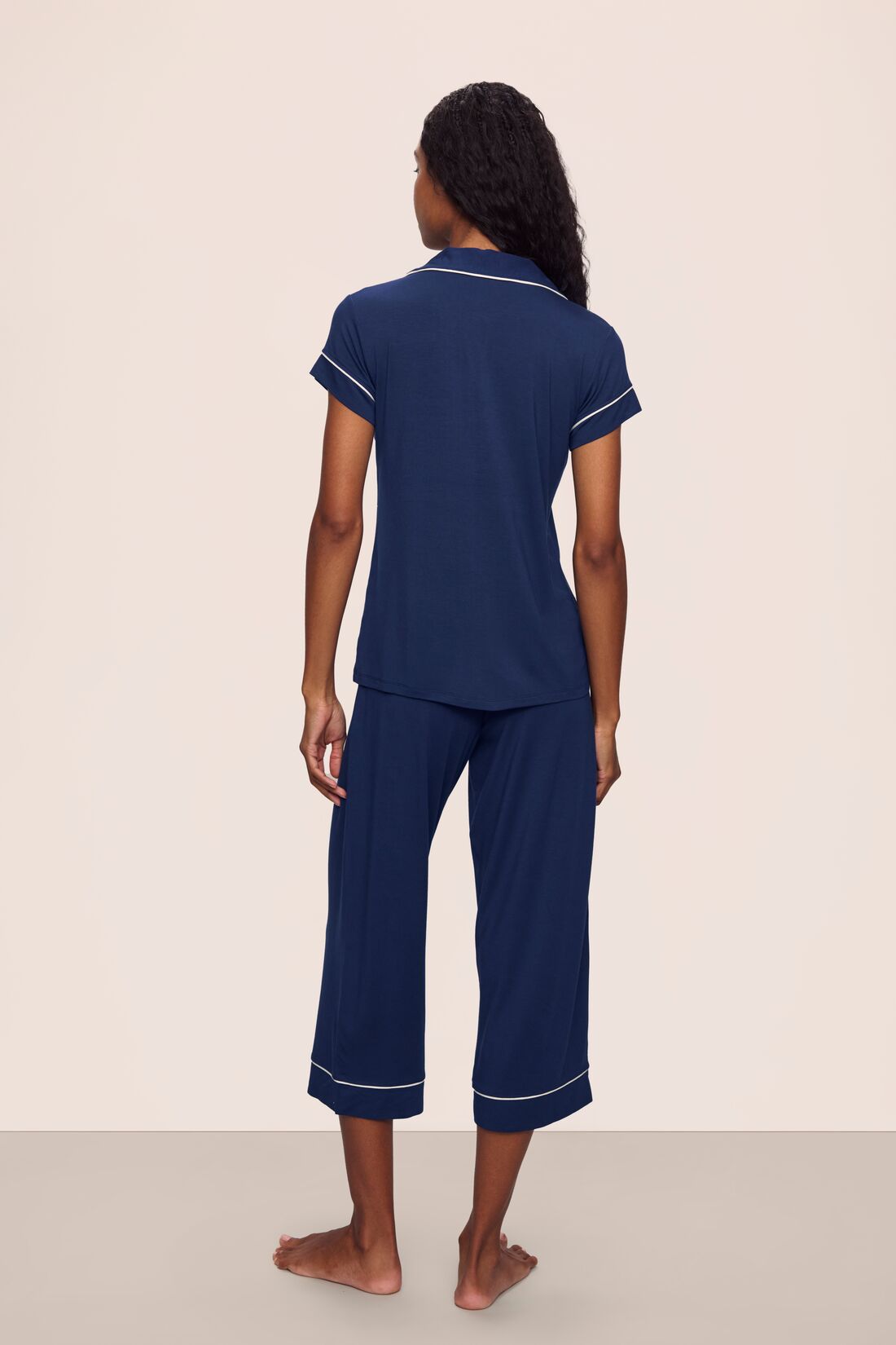 Model is wearing Gisele TENCEL™ Modal Short Sleeve Cropped PJ Set in Navy/Ivory