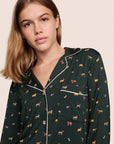 Model is wearing Gisele Printed TENCEL™ Modal Long PJ Set in Holiday Dog Pine/Ivory