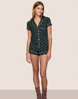 Model is wearing Gisele Printed TENCEL™ Modal Long PJ Set in Holiday Dog Pine/Ivory