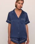 Model is wearing Inez Washable Silk Short PJ Set in Rose Navy/Champagne