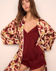 Model is wearing Inez Washable Silk Long Robe in Botanical Flower Merlot and Washable Silk Lace Cami and Short Set in Merlot/Merlot