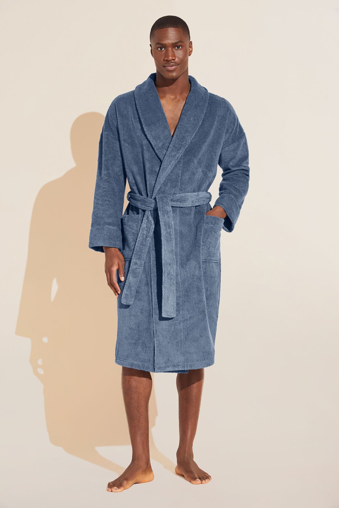 Model wears Terry Gender Neutral Robe in Coastal Blue.