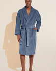 Model wears Terry Gender Neutral Robe in Coastal Blue.