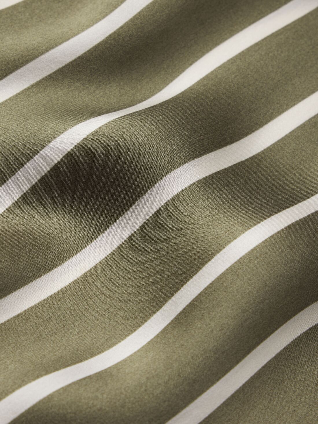 Model is wearing Inez Washable Silk Printed Long PJ Set in Classic Stripe Moss/Moss.