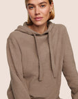 Model is wearing Recycled Boucle Hoodie in Deep Taupe
