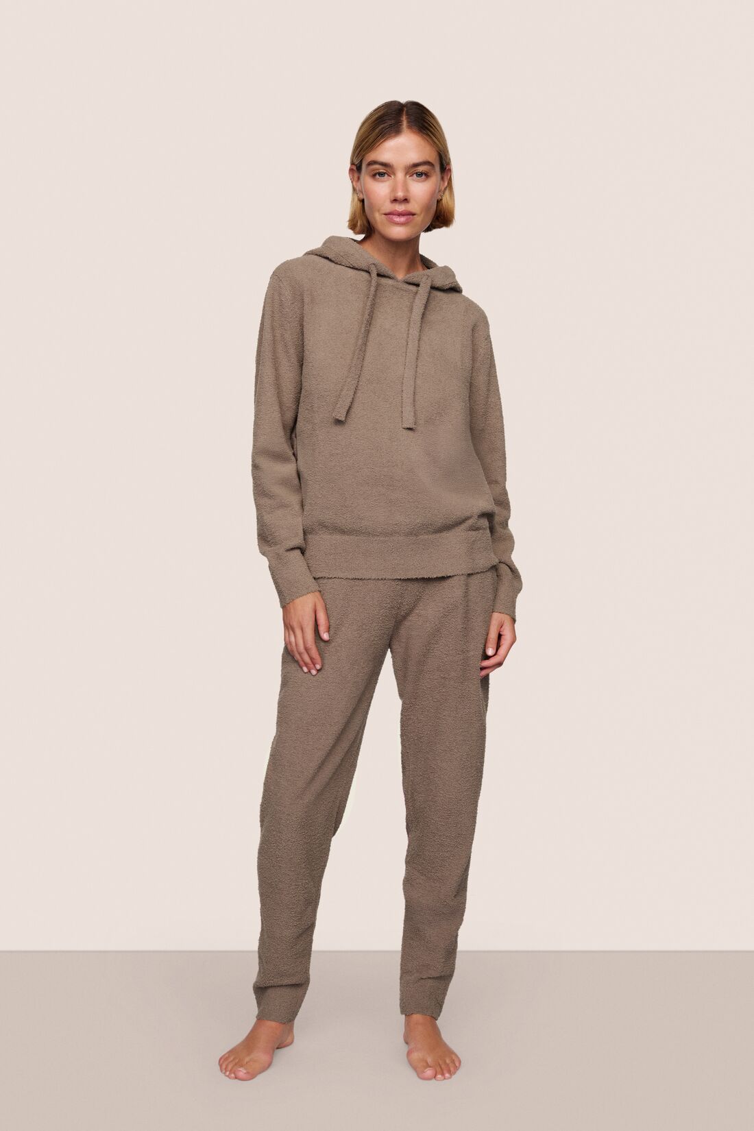Model is wearing Recycled Boucle Hoodie in Deep Taupe