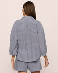 Model is wearing relaxed quarter sleeve top in gingham white/navy