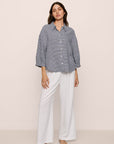 Model is wearing relaxed quarter sleeve top in gingham white/navy
